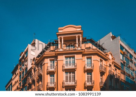orange corner building with darken blue sky