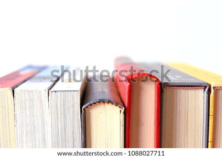 Close-up of multi-color  books line selective focus and shallow depth of field