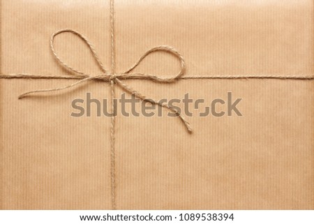 Rough twine bow on kraft wrapping paper background