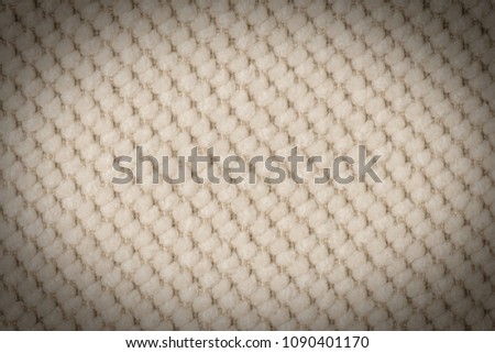 close up of a woolen fabric of beige color. Abstract background, empty template. 