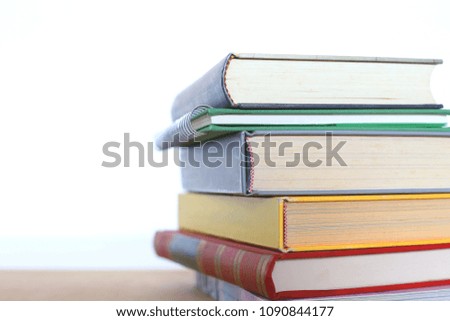 Close-up of the book stack on the floor selective focus and shallow depth of field