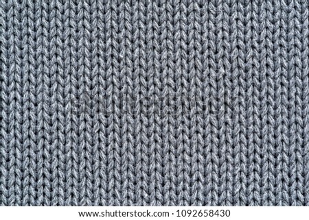 background and texture of knitted woolen or cotton fabric closeup silvery color