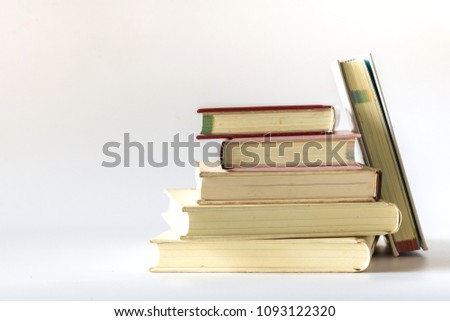 Stack of old books isolated on white background.