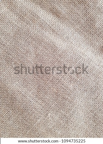 Top view of natural brown hessian cloth or gunny sack. Hessian cloth is an inexpensive fabric or garment made of hessian or burlap formed of jute, coarsely woven fabric. Abstract texture background