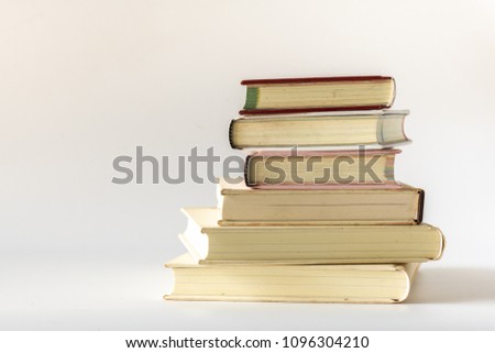 Stack of old books isolated on white background.