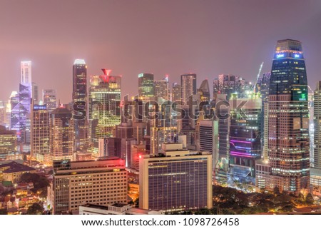 Aerial view of business, residential and under construction buildings skyscrapers at Singapore city center. Modern cityscape at blue hour