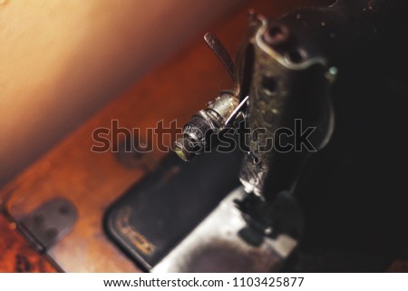 Old antique sewing machine close up. Vintage sewing machine. Tailoring concept.