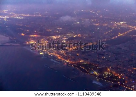 Night flight over Tel Aviv and Mediterranean Sea during landing at International Airport. Israel