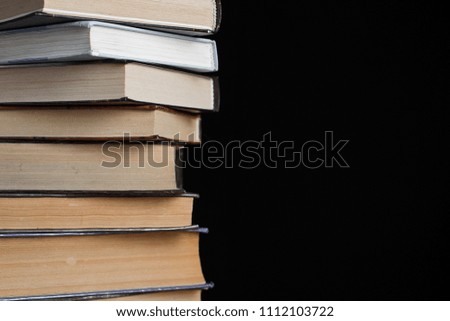 A stack of books on a black background.