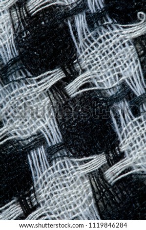 Texture of the background image. Close-up. cloth in a box. Threads white and black