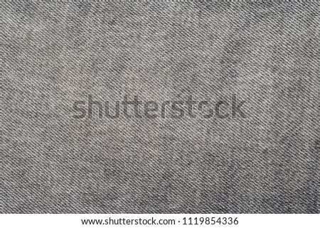Texture of a gray old jeans fabric.