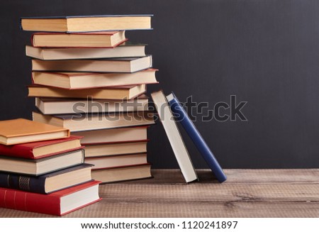 
a stack of books on the table in the classroom