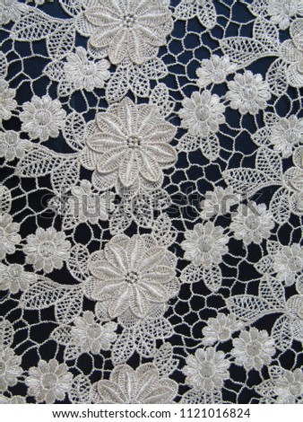             White lace on a black background.                  