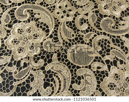 Gold lace on a black background.                               