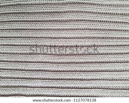 White knitted with a pattern textured background