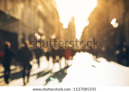 Blurred background made of people walking through the city