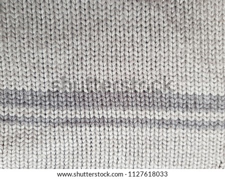 Christmas ornamental knitting with strips. knitted sweater background texture. Real knitted fabric textured background