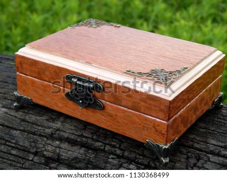 Casket of wood Lacewood handmade on a green background