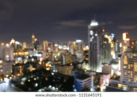 Abstract background from blurred business city center light  from office building downtown at night with urban night light bokeh defocused background.  cityscape at twilight time.
