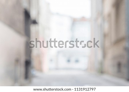 Abstract blurred background of an empty city street with building walls
