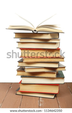 Science and education -  Pile group of red books one open top front view on the wooden table and white background.