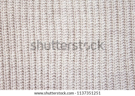 Texture of a knitted fabric close-up, machine knitted