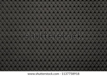 uniform corrugated texture of synthetic fabric or textile material of black color and closeup for a background