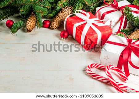 Christmas wooden background with fir tree branches, pine cones and christmas tree balls copy space above frame