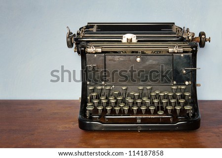 Old vintage typewriter on a rustic wooden table