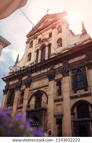 Catholic church of St. Peter and Paul in Lviv, Ukraine. Ancient cathedral on sky background with flowers in front