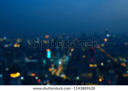 Blurred aerial view of modern office building tower and skyscraper, night time, Bangkok Thailand