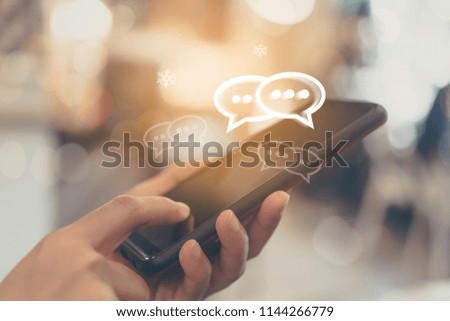 Women hand using smartphone typing, chatting conversation in chat box icons pop up. Social media maketing technology concept.Vintage soft color tone background.