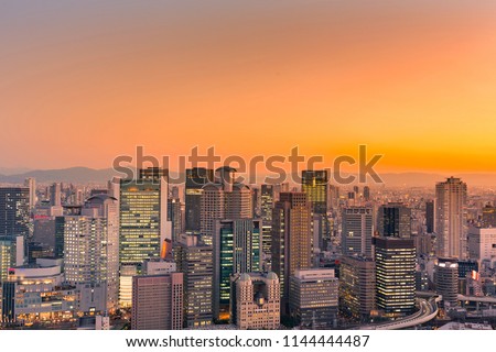 Osaka city central business downtown with sunset sky background, Japan