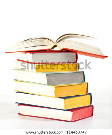 Multicolored stacked books on neutral background