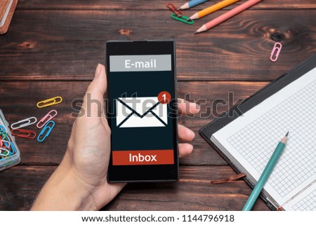 The woman received an e-mail online on a mobile phone. Message online icon.