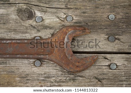 Old tools on wooden background

