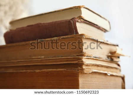 A stack of old tattered books in the library