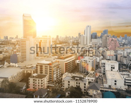 Balcony on the hotel in with blurred abstract background of night light of cityscape growth  and sunset at evening time. Aerial view of a Downtown Thailand at sunset. View business modern district.