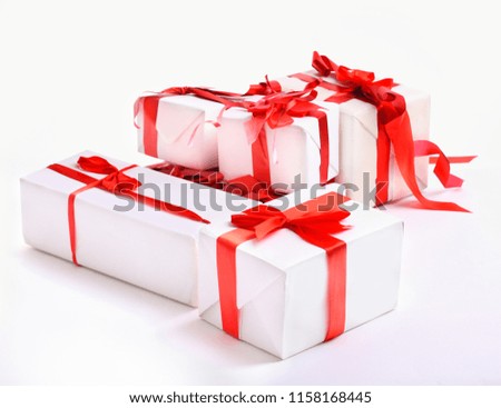stack of red gift boxes decorated with bow isolated on white 