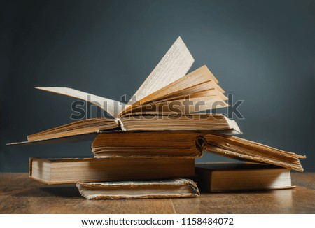 An open old book on a wooden table