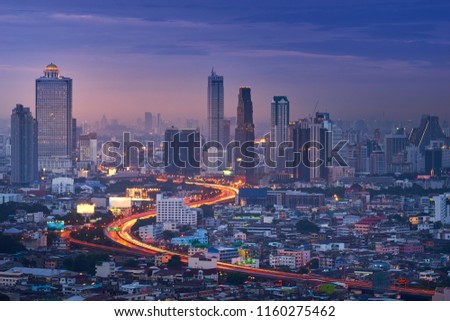 scenic of sweet twilight of cityscape with s-curve of expressway and light tail of traffic 