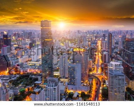 Aerial view of Bangkok skyline and skyscraper on Silom road center of business in capital. Modern city and BTS skytrain with Chao Phraya river at Bangkok Thailand on sunrise