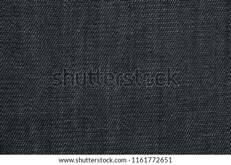 Closeup black color jean denim textures. Texture jean surface background. Concept of shopping and choosing jean , Buy and Sell. Jean fashion