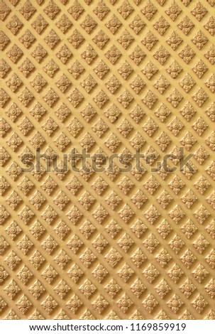 Vertical image of golden Thai pattern background.Antique Thai stucco pattern or 