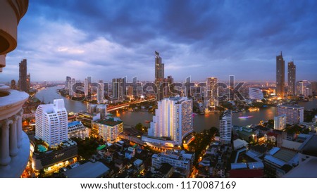 Bangkok city skyline with Chao Phraya River at dusk against light streaks of boat in Thailand, cityscape panorama concept