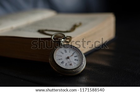 old watch with old book 