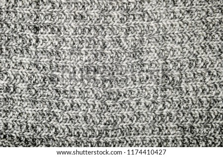 Warm wool gray knitted crumpled plaid. Texture, background.