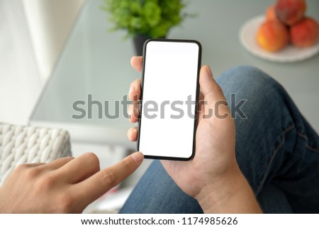 man hand holding phone with isolated screen in room of house
