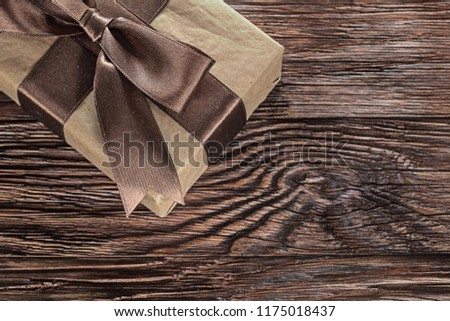 Brown gift box on vintage wooden board horizontal image.