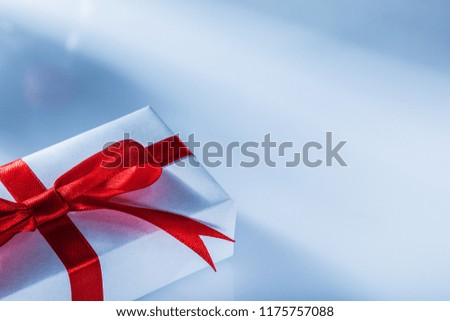 Red present box on white background front view.